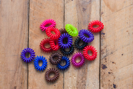 The colorful hair bands on a wooden battens.の写真素材