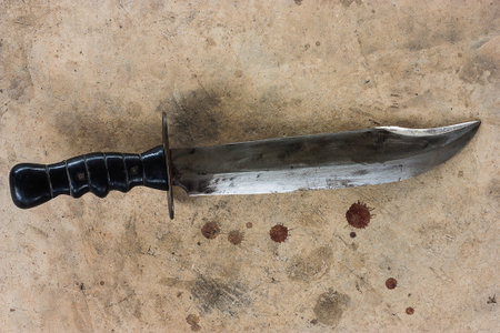 A large knife on the old cement floor.の写真素材