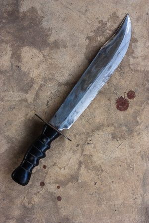 A large knife on the old cement floor.の写真素材