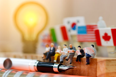 Miniature people reading and sitting on wood with lamp idea using as background, education or business concept.の写真素材
