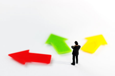 Miniature people standing whit arrow pathway choice. Business decision concept.の写真素材