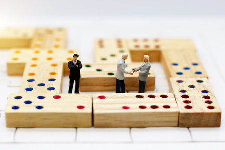 Miniature business people handshake. Agreement, partnership and business conceptの写真素材