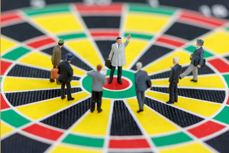 miniature business team standing on the dartboard. Target business concept.の写真素材