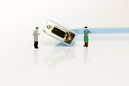 miniature people with console network cable on the white background. Technology and Network...