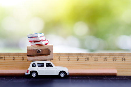 Miniatures  car with ruler, book and pencil. education or business concept.の写真素材