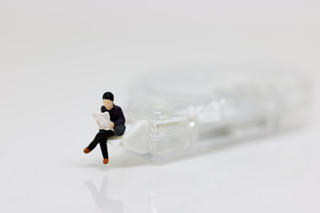 Miniature people reading  using as background, education or business concept.の写真素材