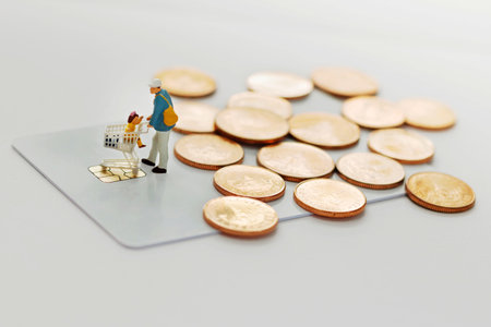 Miniature people :  Father and children go shopping / buying with cart on credit card and coins....