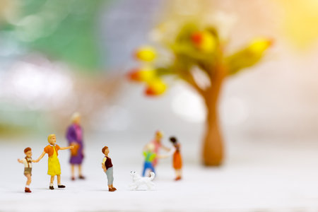 Miniature people, children and family enjoy with dog , happy family day concept.の写真素材