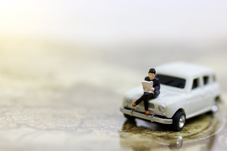 Miniature people reading and sitting on car  using as background, education or business concept.
の写真素材