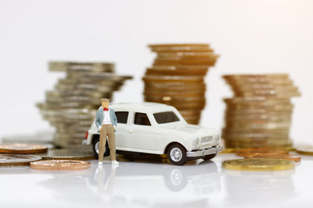Miniature business people standing with car and coin money. Finance, investment and growth in business concept.
の写真素材
