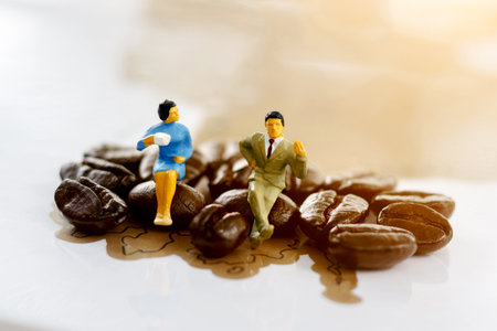 Miniature people sitting on coffee bean, Coffee time concept.の写真素材