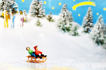 Miniature kids playing fun with snow. の写真素材