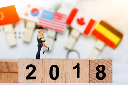 Miniature People Couple Lover Standing on wood block with number 2018, International happy family day concept.
の写真素材
