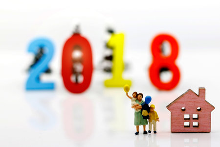 Miniature people, Mother and children holding balloon with home ,family day concept.