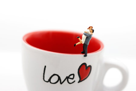 Miniature people Couple Lover standing on cup off coffee, lovely concept.の写真素材