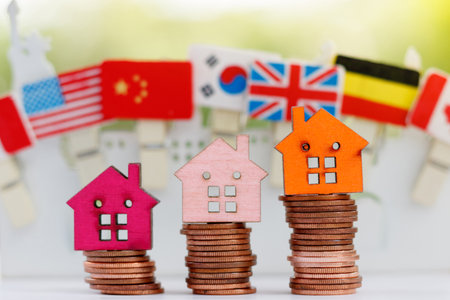 Wooden house model on coins stack. Property, Finance, investment and growth in business concept.