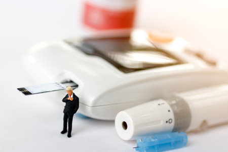 Miniature people looking time with glucose meter of diabetes , business and health care concept.の写真素材