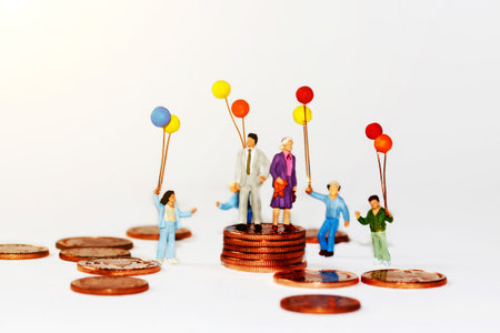Miniature people, family and children enjoy with colorful balloons on coins stack, happy family day concept.
の写真素材