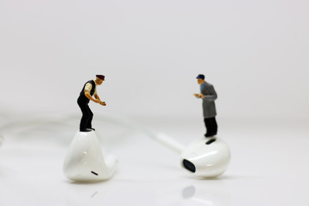Minature people standing on earphone for listening to the music . Relaxation, hobby and musicians concept.
の写真素材
