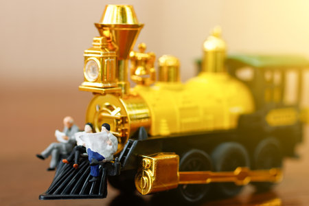 Miniature people reading and sitting on yellow train, education or business concept.
の写真素材