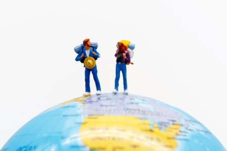 Miniature people, backpackers on the globe walking to destination. travel and business concept.