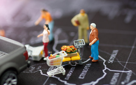 Concept of tourism, shopping or business. miniature family with shopping cart and pick up car on the map.
の写真素材