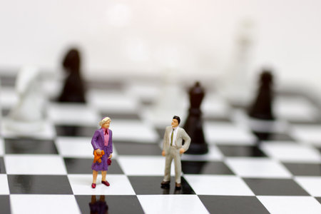 Miniature business people standing on shessboard, Strategy of teamwork in business