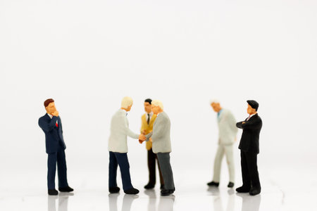 Miniature businessman handshake, business concept.の写真素材