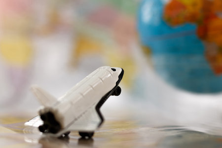 Miniature white airplane on globe, travel concept. の写真素材