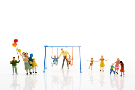 Miniature people, children and family enjoy with swing , happy family day concept.の写真素材
