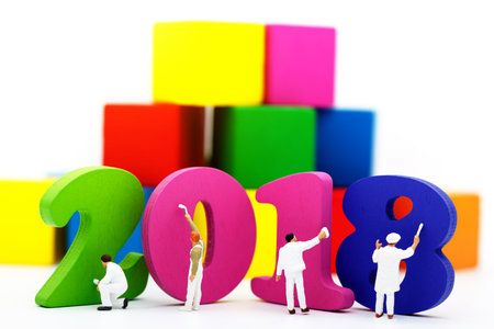 Miniature people: Workers holding a paint brush painting  2018 on a white background.  Happy new year, business concept.の写真素材