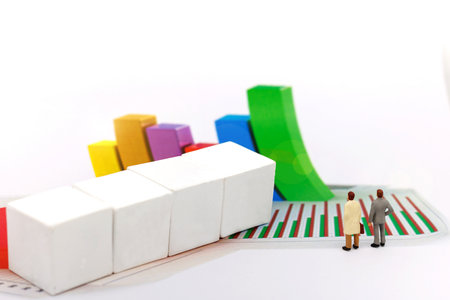Miniatrue people: Businessman looking at the graph. Concept of business.