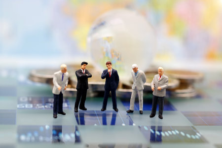 Miniature people, businessman are thinking with globe on coins stack. Concept of Strategy with thinking.の写真素材