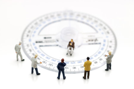 Miniature people: Business team standing around Circle ruler. の写真素材