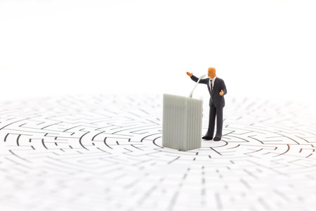 Miniature people: businessman stand with the podium on center of maze. Concepts of finding a solution, problem solving and challenge.の写真素材