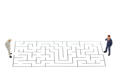 Miniature people: Businessman standing on start point of maze and  thinking how to solve this problem. Concepts of finding a solution, problem solving and challenge.の写真素材