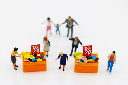 Miniatrue people: Shoppers buy goods on sale with discount tray. Tourism, shopping or business concept.の写真素材