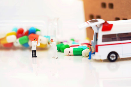 Miniature people: Doctor and patient standing with ambulance  and drugs. Health care and emergency concept.の写真素材
