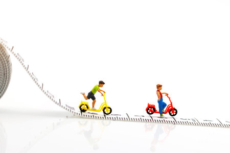 Miniature people: Children palying with bicycle.の写真素材
