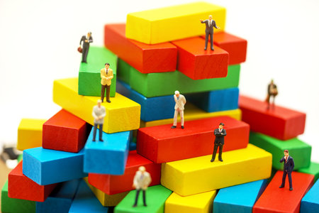 Miniature business people sitting on wood block , recruitment finding employee and business concept.の写真素材