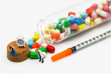 Miniature people: Patients sitting with drugs and clock. Health care and business concept.の写真素材