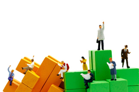 Miniature business people sitting on wood block , recruitment finding employee and business concept.の写真素材
