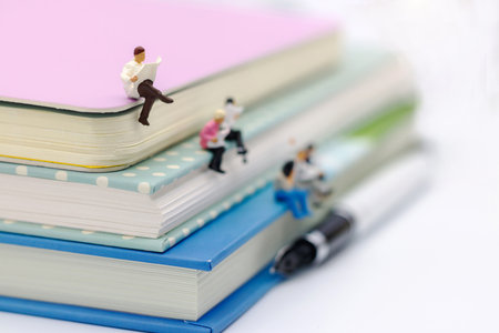 Miniature people: Business team reading book, education or business concept.の写真素材