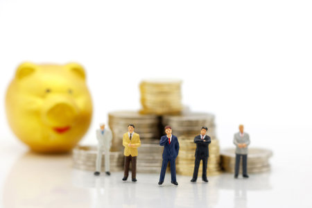 Miniature people:  Businessmen standing with coins stack, Finance, investment and growth in business concept.の写真素材