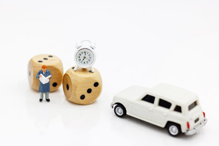 Miniature people: Businessman reading book with dice. Eduation and business Concept.