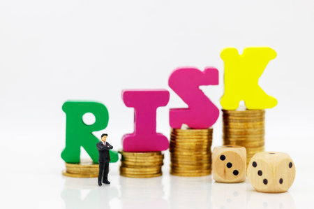 Miniature people: Businessman standing with dice and coins stack.. Concept of investment risks.