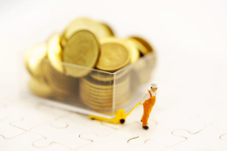 Miniature people: Workers transport coins money. Success, Finance, investment and growth in business concept.の写真素材