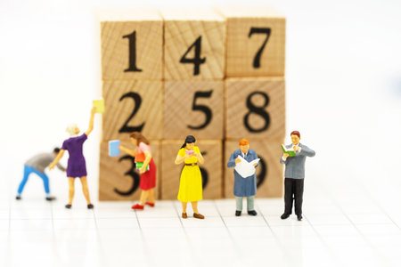 Miniature people: Business team reading book with block number, education and business concept.の写真素材