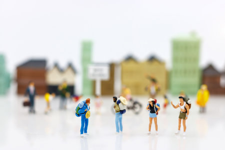 Miniature people: Traveller with backpack walking on the path of tourism. Travel, explore and...
