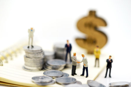 Miniature people:  Businessmen standing with coins stack, Finance, investment and growth in business concept.の写真素材